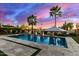 Backyard pool area with travertine deck, lounge chairs, and lush landscaping, creating a relaxing outdoor oasis at 3234 N 163Rd Dr, Goodyear, AZ 85395