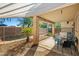 Shaded outdoor patio featuring stone flooring, outdoor furniture, and a view of the caged pool at 3299 E Boston St, Gilbert, AZ 85295