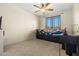 Bright bedroom featuring a ceiling fan, window with blinds, and a cozy daybed at 3299 E Boston St, Gilbert, AZ 85295