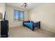 Cozy bedroom with a twin bed, window, and natural light at 3299 E Boston St, Gilbert, AZ 85295