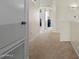 Upstairs hallway with neutral walls and carpet with the doors to the rooms visible at 3299 E Boston St, Gilbert, AZ 85295