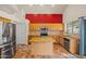 Modern kitchen with light wood cabinets, center island, and stainless steel appliances, blending style and functionality at 3299 E Boston St, Gilbert, AZ 85295