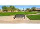 Park bench with views of lush green grass, walking path, palm trees and well-manicured landscaping at 3299 E Boston St, Gilbert, AZ 85295