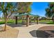 Park picnic structure with charcoal grill, seating and a basketball court at 3299 E Boston St, Gilbert, AZ 85295