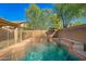 Sparkling pool with brick trim, surrounded by privacy fence and beautiful green trees at 3299 E Boston St, Gilbert, AZ 85295