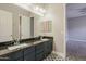 A well-lit bathroom with double sinks, decorative tile flooring, and plenty of room for morning preparation at 3373 E Oriole Way, Chandler, AZ 85286