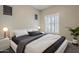 Contemporary bedroom featuring a sleek platform bed, stylish bedside lamps, and bright white plantation shutters at 3373 E Oriole Way, Chandler, AZ 85286