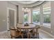 Bright breakfast nook overlooking the backyard pool area with elegant lighting and a table with seating at 3373 E Oriole Way, Chandler, AZ 85286