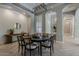 Formal dining room features a dark wood table, herringbone floors, and modern recessed lighting at 3373 E Oriole Way, Chandler, AZ 85286