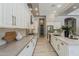 A modern kitchen features white cabinets, stainless steel appliances, and a large island with barstool seating at 3373 E Oriole Way, Chandler, AZ 85286