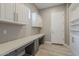 Well-organized mud room with custom cabinetry, ample counter space, and durable tile floors at 3373 E Oriole Way, Chandler, AZ 85286