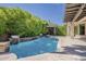 Resort-style pool area with mature landscaping, a cabana, and a tranquil waterfall feature at 3373 E Oriole Way, Chandler, AZ 85286