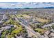 Aerial view of the community near a golf course with mountain views in the distance at 34969 N Open Range Dr, San Tan Valley, AZ 85144