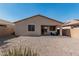 Backyard of home with gravel landscaping, a covered patio, and neutral stucco exterior at 34969 N Open Range Dr, San Tan Valley, AZ 85144