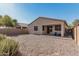 Backyard featuring a covered patio and low maintenance desert landscaping, perfect for outdoor living at 34969 N Open Range Dr, San Tan Valley, AZ 85144