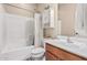 Bathroom featuring white subway tile in the shower and a wood vanity with good storage at 34969 N Open Range Dr, San Tan Valley, AZ 85144