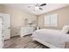 Bright bedroom with wood-look flooring, a decorative dresser and neutral tones at 34969 N Open Range Dr, San Tan Valley, AZ 85144