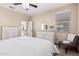 Bright bedroom with wood-look flooring, a decorative dresser and a view into the Primary bath at 34969 N Open Range Dr, San Tan Valley, AZ 85144