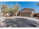 Charming single-story home with a two-car garage, desert landscaping, and covered front porch at 34969 N Open Range Dr, San Tan Valley, AZ 85144