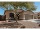 Charming single-story home with a two-car garage, desert landscaping, and covered front porch at 34969 N Open Range Dr, San Tan Valley, AZ 85144