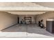 Spacious two-car garage with concrete floor, storage shelves, and various tools/exercise equipment at 34969 N Open Range Dr, San Tan Valley, AZ 85144