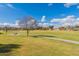 Scenic view of a green space featuring a paved walking path and picnic tables for outdoor enjoyment and community gatherings at 34969 N Open Range Dr, San Tan Valley, AZ 85144