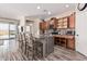 Spacious kitchen featuring an island with barstool seating, modern appliances, and warm wood cabinetry at 34969 N Open Range Dr, San Tan Valley, AZ 85144