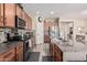 Spacious kitchen featuring an island with barstool seating, modern appliances, and warm wood cabinetry at 34969 N Open Range Dr, San Tan Valley, AZ 85144