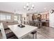 Open-concept living space with dining area and kitchen featuring wood-look flooring and neutral tones at 34969 N Open Range Dr, San Tan Valley, AZ 85144