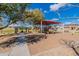 Community playground features a covered picnic area, play structures, and a seesaw on a sunny day at 34969 N Open Range Dr, San Tan Valley, AZ 85144