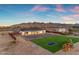 Aerial view showcasing the home, large backyard with artificial turf, and a playground at 35150 N Bell Rd, Queen Creek, AZ 85144