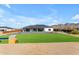 Aerial view of the property featuring the backyard, artificial grass, and nearby mountains at 35150 N Bell Rd, Queen Creek, AZ 85144