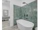 Modern bathroom featuring a standalone tub and tiled accent wall with matte black fixtures at 35150 N Bell Rd, Queen Creek, AZ 85144