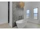 Modern bathroom with a freestanding tub, unique tile work, and natural light at 35150 N Bell Rd, Queen Creek, AZ 85144