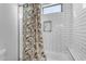 Bright bathroom featuring a tub and shower with white subway tile and decorative shower curtain at 35150 N Bell Rd, Queen Creek, AZ 85144