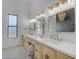 Elegant bathroom with a double vanity, stylish mirrors, and decorative lighting at 35150 N Bell Rd, Queen Creek, AZ 85144