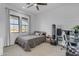 Neutral-toned bedroom with natural light, featuring a desk, punching bag, and minimalist decor at 35150 N Bell Rd, Queen Creek, AZ 85144