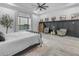 Bright bedroom with ceiling fan, a black accent wall, and views of a playground at 35150 N Bell Rd, Queen Creek, AZ 85144