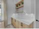 Charming butler's pantry featuring white subway tile backsplash and light wood cabinetry with floating shelves at 35150 N Bell Rd, Queen Creek, AZ 85144