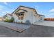 Exterior of the home with white siding, black trim, and manicured landscaping at 35150 N Bell Rd, Queen Creek, AZ 85144