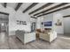 A modern living room with a fireplace, TV, and wooden beams giving a rustic yet stylish feel at 35150 N Bell Rd, Queen Creek, AZ 85144