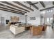 Bright living room featuring wood beam ceilings that flows seamlessly into a modern white kitchen at 35150 N Bell Rd, Queen Creek, AZ 85144