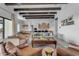 Airy living room with wood beam ceilings, providing a comfortable and stylish entertaining space at 35150 N Bell Rd, Queen Creek, AZ 85144