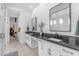 Bright, modern bathroom features dual sinks, sleek countertops and a glass-enclosed shower at 3547 E Bloomfield Pkwy, Gilbert, AZ 85296