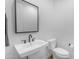 Modern bathroom featuring a sleek white sink, black hardware, and a stylish mirror at 3547 E Bloomfield Pkwy, Gilbert, AZ 85296