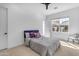 Cozy bedroom with modern minimalist furnishings, and natural light from the window at 3547 E Bloomfield Pkwy, Gilbert, AZ 85296