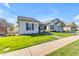 Inviting single-story home with a lush green lawn and well-maintained landscaping with mature shade tree at 3547 E Bloomfield Pkwy, Gilbert, AZ 85296