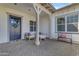 Inviting front porch with neutral furniture and a wreath on the navy blue front door at 3547 E Bloomfield Pkwy, Gilbert, AZ 85296