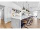 Spacious kitchen with a large marble waterfall island and sleek pendant lighting at 3547 E Bloomfield Pkwy, Gilbert, AZ 85296