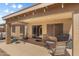 Covered back patio with seating, BBQ, and access to the backyard at 3663 E Camden Ave, San Tan Valley, AZ 85140